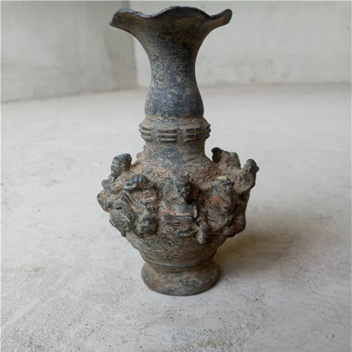 Decorative vase with intricate designs on a plain background