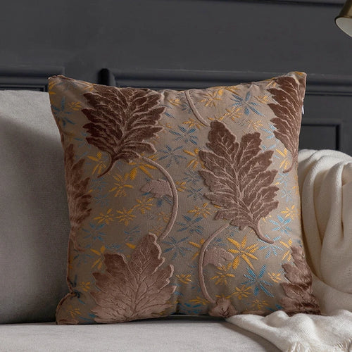 Vibrant embroidered leaf design on decorative throw pillow cover from The Finishing Touch Decor, perfect for accenting sofas or beds