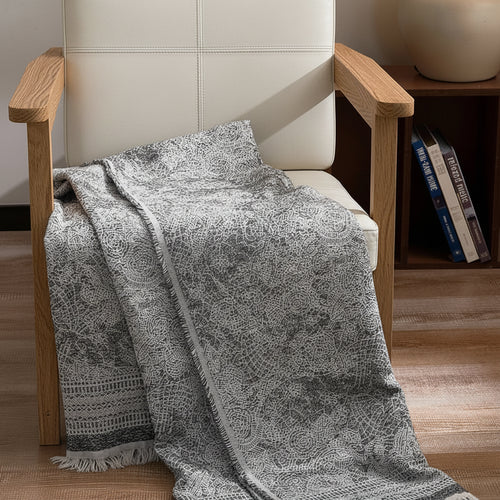 Light pure cotton grey gauze blanket by The Finishing Touch Decor, soft and breathable fabric with a delicate gauze texture.