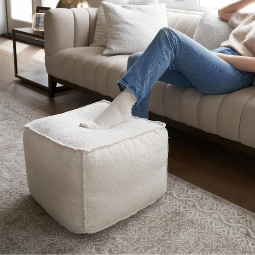 Beautiful boucle pouf ottoman by The Finishing Touch Decor, round, lightweight footrest with textured fabric for living room decor.