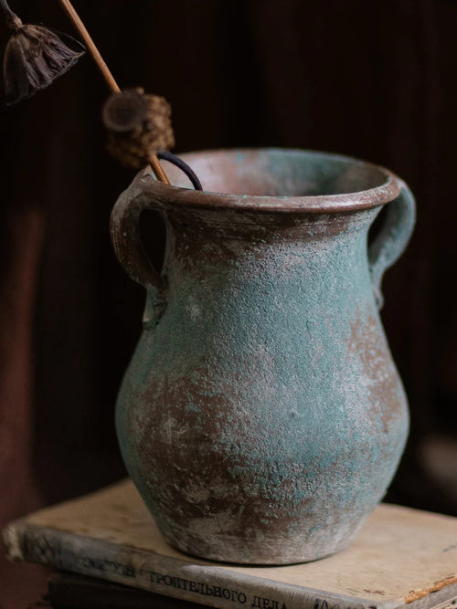 Decorative retro thick earthenware vase by The Finishing Touch Decor, ideal as a dried flower holder in mid-century modern living room decor.