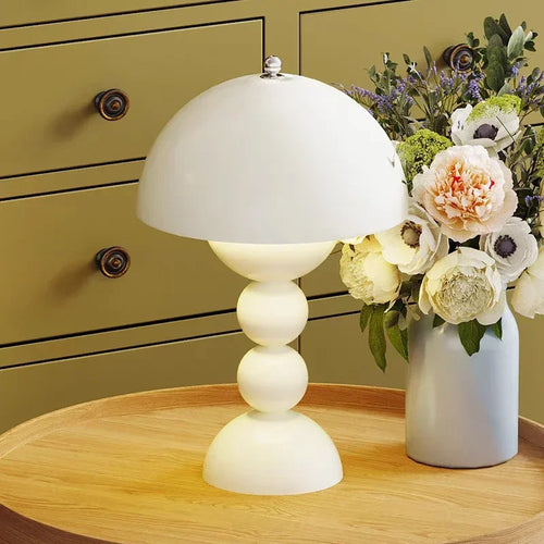 Post-Modern Mushroom USB Table Lamp by The Finishing Touch Decor, dimmable lighting with unique mushroom-shaped design on a table.