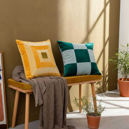 Colorful retro patchwork velvety throw pillows from The Finishing Touch Decor, showcasing vibrant, textured fabric and eclectic design.