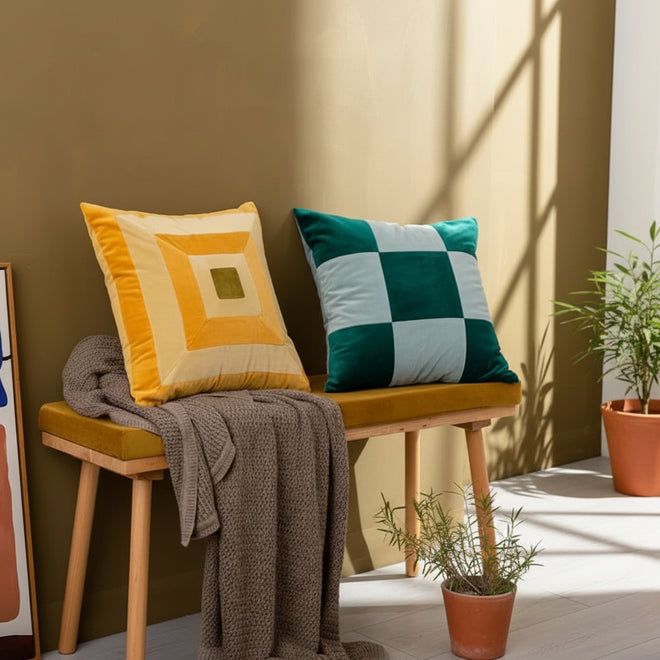 Colorful retro patchwork velvety throw pillows by The Finishing Touch Decor, showcasing vibrant, textured fabric and decorative design.