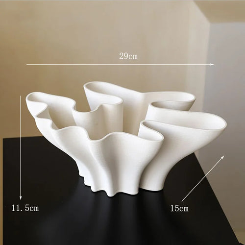 White ceramic Sculpted Waves Scandi vase with textured wave design, ideal for modern decorative display.