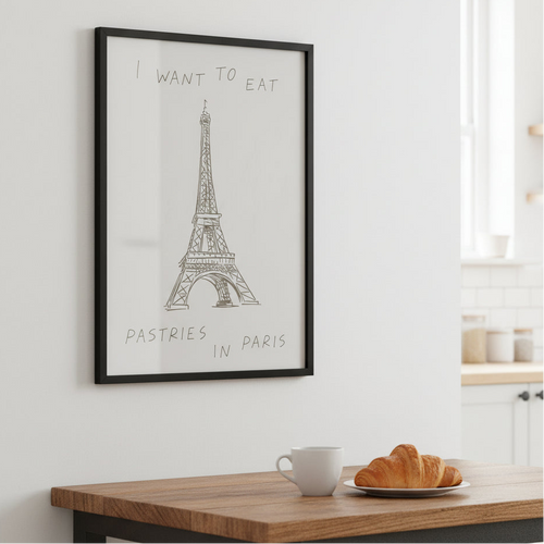 Framed print of the Eiffel Tower with text on a beige couch background