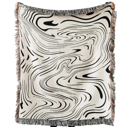 Abstract wavy ink swirl fringed throw blanket by The Finishing Touch Decor, showing a soft, textured blanket with fringed edges.