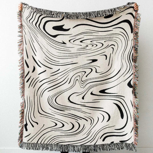 Abstract wavy ink swirl fringed throw blanket from The Finishing Touch Decor featuring a stylish, flowing design in soft, textured fabric.