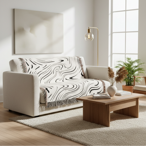 Abstract wavy ink swirl fringed throw blanket by The Finishing Touch Decor, featuring a flowing ink-inspired pattern and textured fringes.