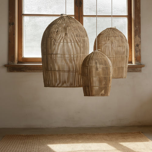 Wabi Sabi rattan wicker pendant light by The Finishing Touch Decor hanging from ceiling, natural woven design for warm interior lighting.