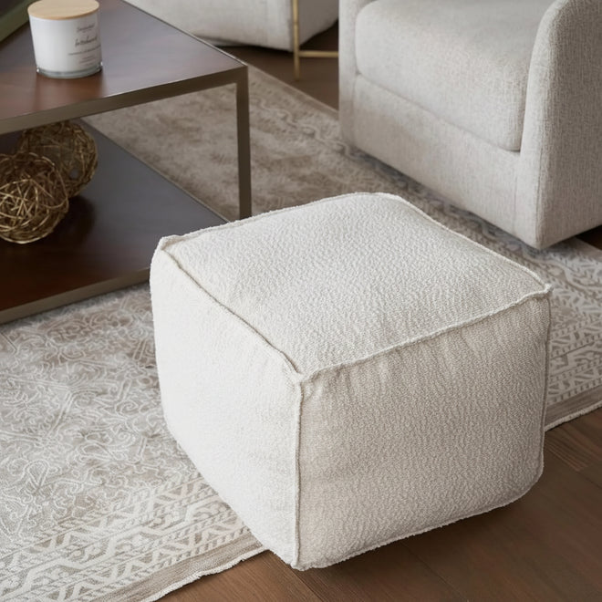 Lightweight boucle pouf ottoman by The Finishing Touch Decor, round foot rest with plush fabric and stylish decor appeal.