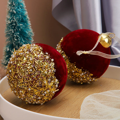 Red velvet and glitter Christmas ball ornaments for holiday decor, featuring shiny and textured finishes.