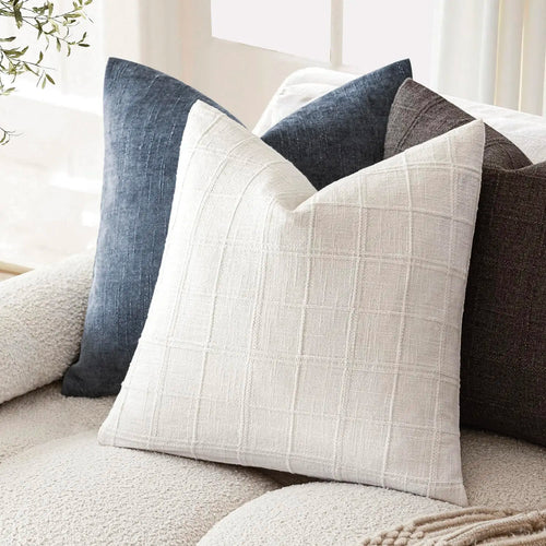 Textured neutral linen cotton throw pillow cover from The Finishing Touch Decor, showcasing soft fabric and subtle woven pattern.