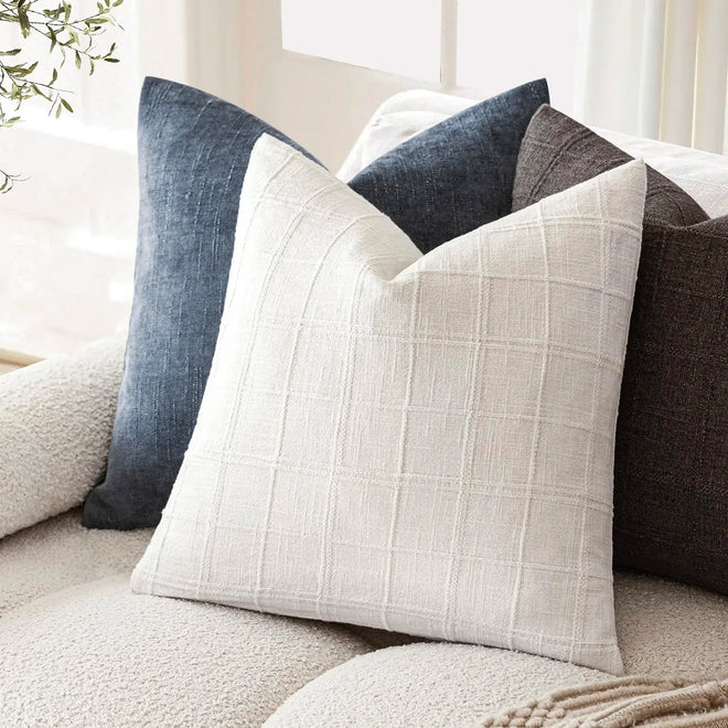 Textured neutral linen cotton throw pillow cover from The Finishing Touch Decor, showcasing soft fabric and subtle woven pattern.
