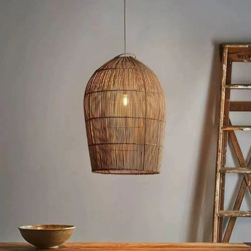 Wabi Sabi rattan wicker pendant light by The Finishing Touch Decor hanging from ceiling with woven rattan design.