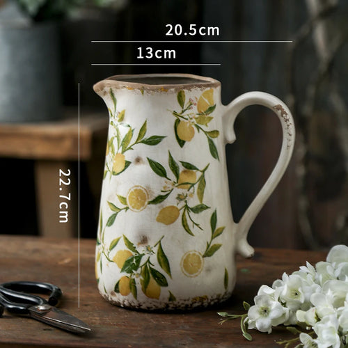 Decorative farmhouse-style ceramic pitcher vase with a vintage cottage design, perfect for rustic home decor.