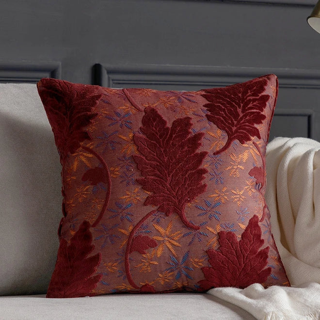 Vibrant embroidered leaf design on decorative throw pillow cover from The Finishing Touch Decor, perfect for accenting sofas or beds.