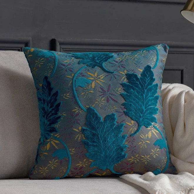Vibrant embroidered leaf throw pillow cover from The Finishing Touch Decor, featuring colorful leaf patterns on fabric.