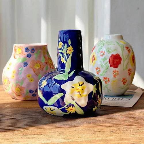 French hand-painted ceramic mug by The Finishing Touch Decor with floral design, used as a vintage-style flower vase.