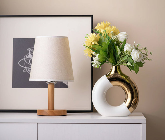 Gold accent ceramic donut vase with modern design, decorative vase from The Finishing Touch Decor, featuring a smooth, glossy finish.