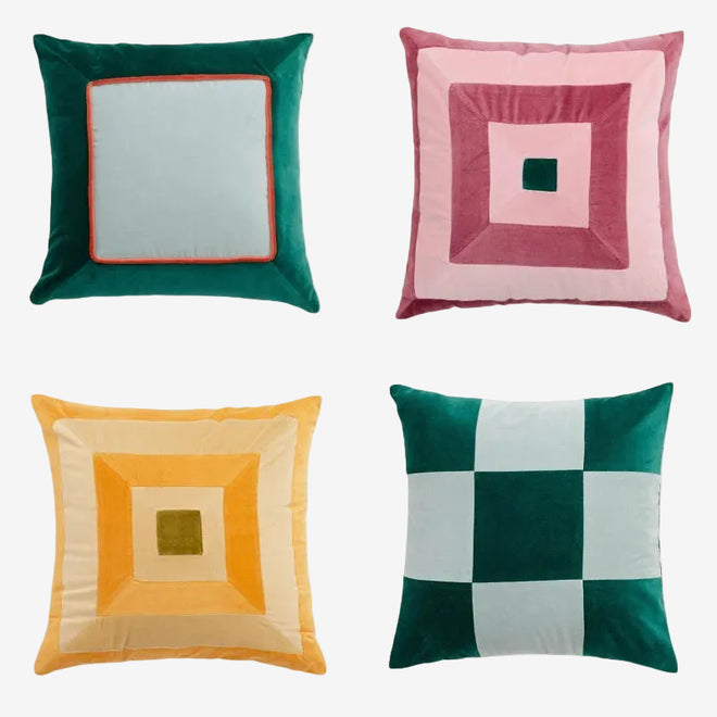 Colorful retro patchwork velvety throw pillows by The Finishing Touch Decor, showcasing vibrant, textured fabric and unique design.