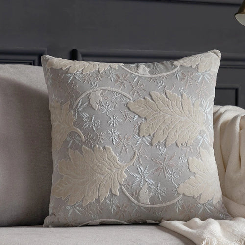 Vibrant embroidered leaf design on decorative throw pillow cover from The Finishing Touch Decor, perfect for adding color to sofas.