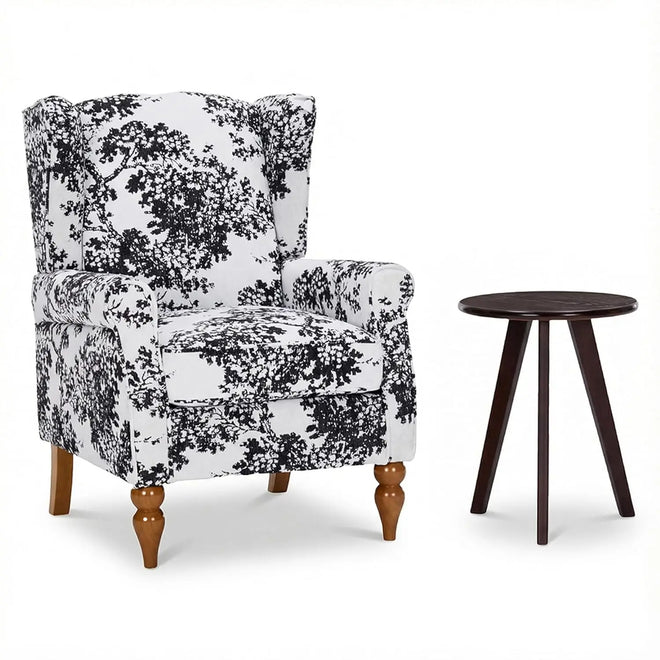 Upholstered wingback floral accent chair with matching small table, decorated with vibrant floral fabric, by The Finishing Touch Decor.