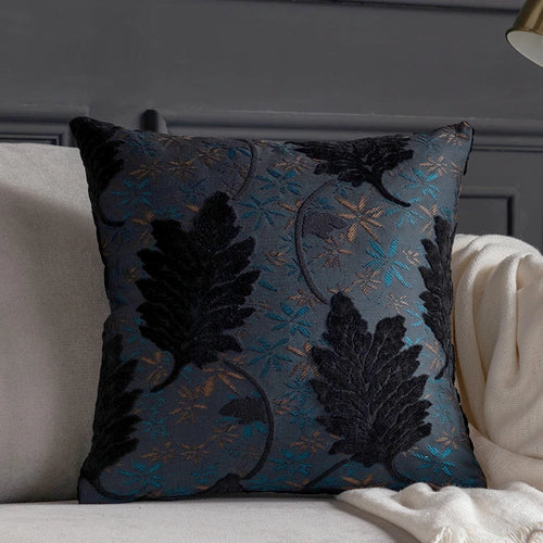 Vibrant embroidered leaf design on decorative throw pillow cover from The Finishing Touch Decor for sofa or bed decor.