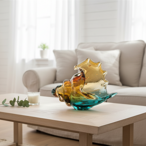 Coastal hand-blown glass conch shell sculpture as table art, featuring vibrant colors and intricate detailing by The Finishing Touch Decor.