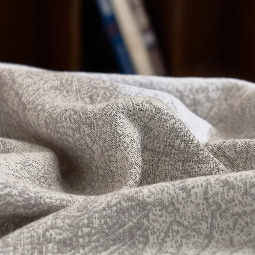 Soft grey cotton gauze blanket from The Finishing Touch Decor, featuring lightweight, breathable fabric and a cozy textured design.