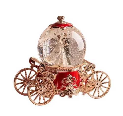 Decorative glass ball with fairy inside on a red and gold carriage base