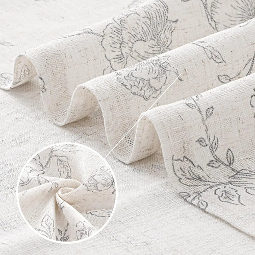 Vintage ecru and grey floral sketch pattern farmhouse curtains by The Finishing Touch Decor hanging on a window.