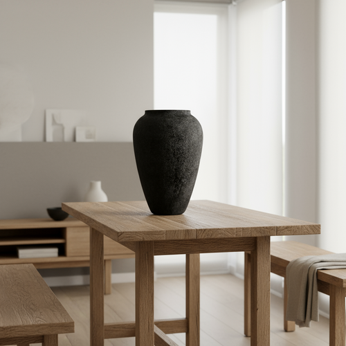 Black vase on a wooden table in a minimalistic room