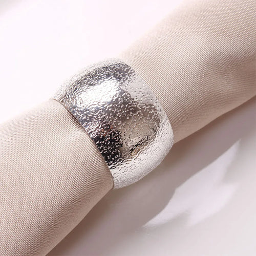Set of four gold or silver metal dinner napkin rings for holiday decor, featuring elegant accents by The Finishing Touch Decor LLC.