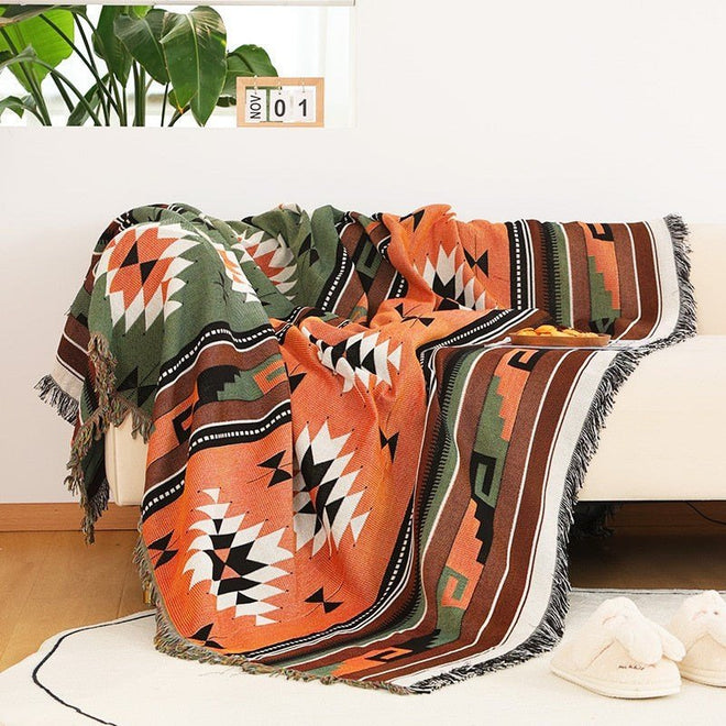 Large colorful boho ethnic throw blanket by The Finishing Touch Decor with vibrant patterns and bold design, perfect for cozy decor.