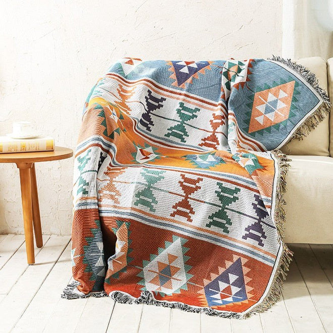 Large colorful boho ethnic throw blanket from The Finishing Touch Decor, LLC, featuring vibrant, bold bohemian plaid design.