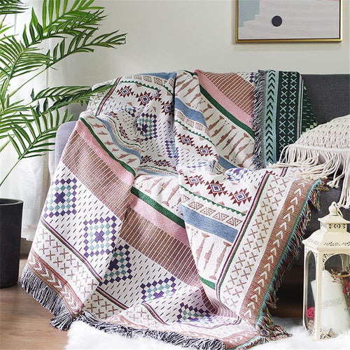 Large colorful boho ethnic throw blanket from The Finishing Touch Decor, LLC, featuring bold, vibrant patterns and soft woven fabric.